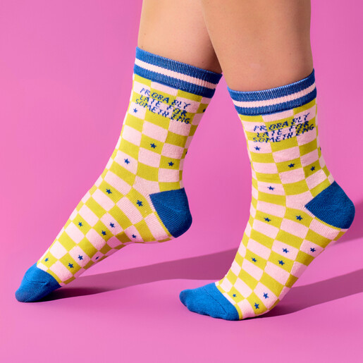 Model wearing pink and lime green Probably Late For Something checkerboard socks