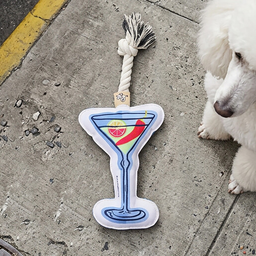 Martini pet rope toy placed next to a white poodle dog