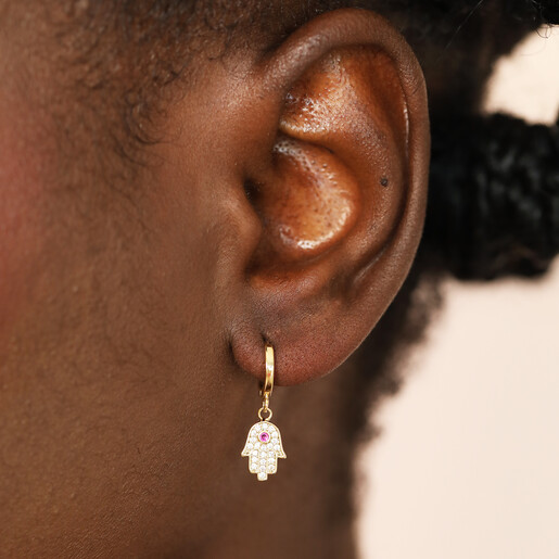 spiritual huggie hoop earrings on model 