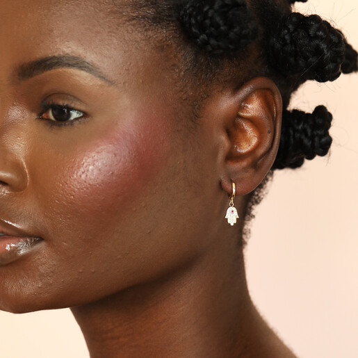 model shot of gold huggie hoop earrings