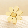 Detailed close-up of a gold stainless steel eight-petalled daisy stud earring.