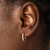 close up of sparkly hoop earrings on model
