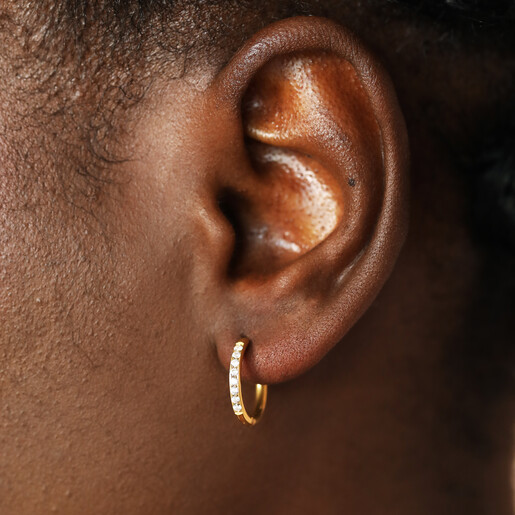 close up of sparkly hoop earrings on model