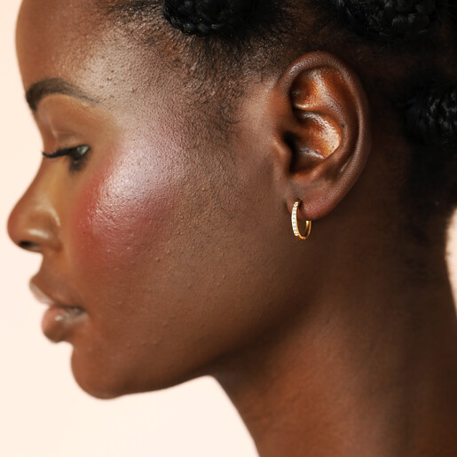 model shot of gold huggie hoop earrings
