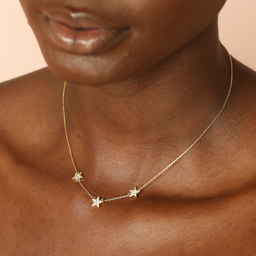 charm necklace in gold on model