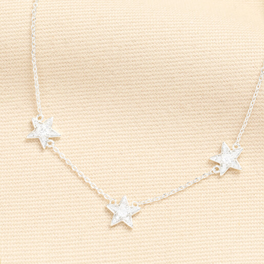 Close up view of the silver plated triple star charm necklace with sparkling crystals.