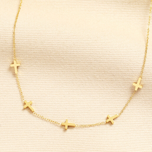 Gold stainless steel chain necklace featuring small cross charms spaced along the fine chain
