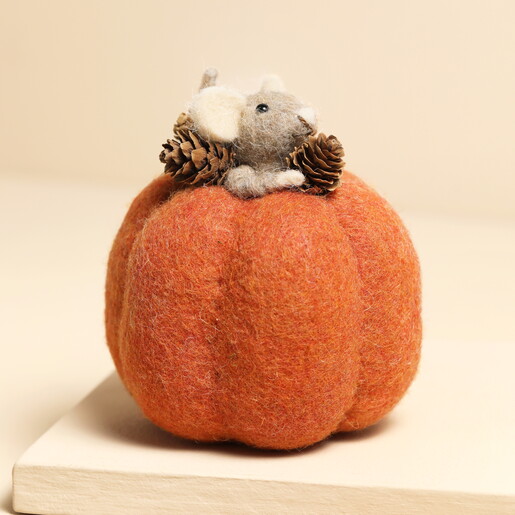 Felt Mouse in a Pumpkin Standing Decoration on a Beige Background