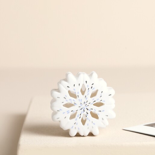 Front view of the white ceramic snowflake photo holder stand
