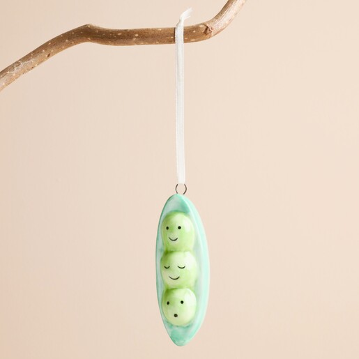 Ceramic peas in a pod tree ornament hanging from a rustic wooden branch