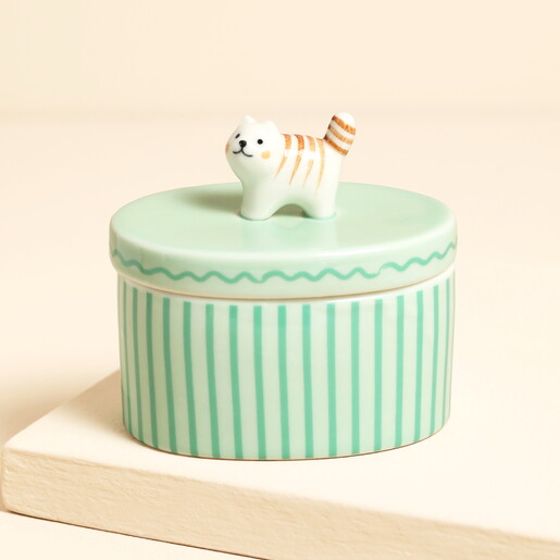 Green oval ceramic candle pot with striped cat handle on the lid