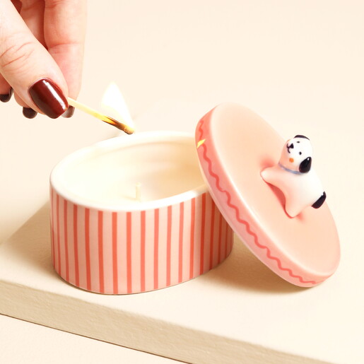Lighting the wick of the pink striped dog candle pot
