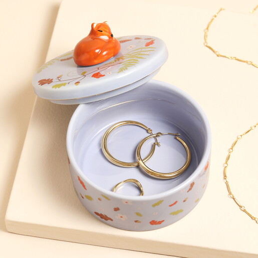 Open purple ceramic fox trinket pot filled with gold hoop earrings and ring