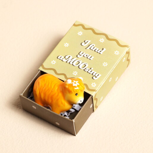 highland cow token in orange with packaging
