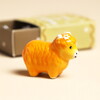 orange ceramic highland cow with flower