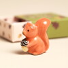 orange squirrel token with acorn