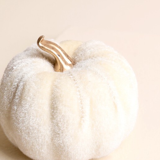 Close-up of the mini white velvet pumpkin decoration showing plush ribbed texture and stem.
