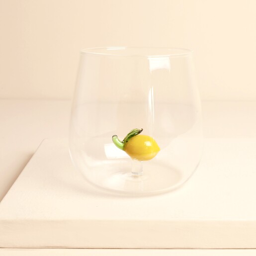 Clear glass tumbler with a 3D yellow glass lemon figurine inside