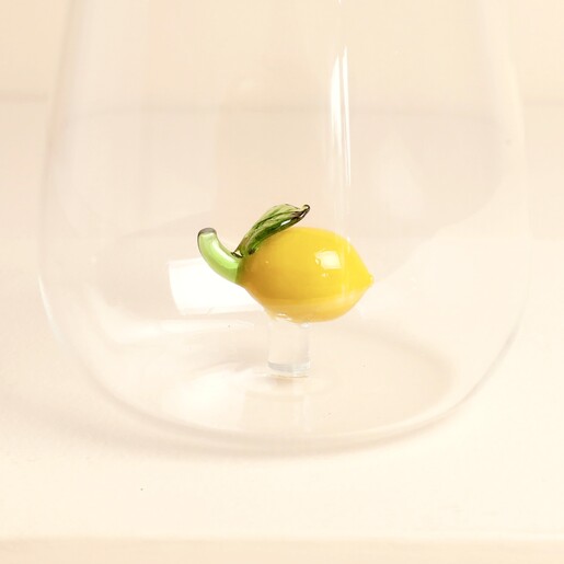 Close up of yellow glass lemon figurine attached to the bottom of tumbler