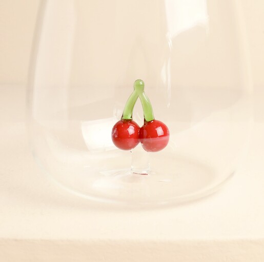 Close-up of the 3D glass red cherries inside the clear tumbler base