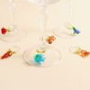 Glass stemware styled with colourful glass sealife charms around the bases.
