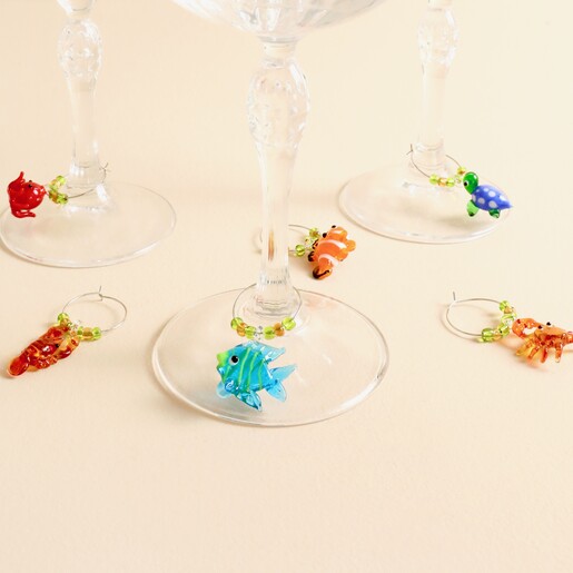 Glass stemware styled with colourful glass sealife charms around the bases.