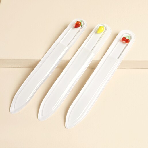 Trio of glass nail files topped with strawberry, lemon, and cherry charms in clear sleeves