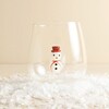 Clear glass drinking tumbler with a small 3D snowman inside on faux snow