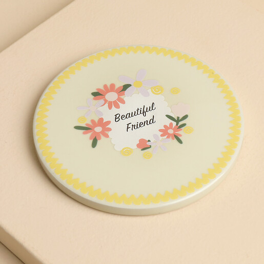 Round ceramic coaster featuring colourful floral illustration and Beautiful Friend text with yellow wavy border