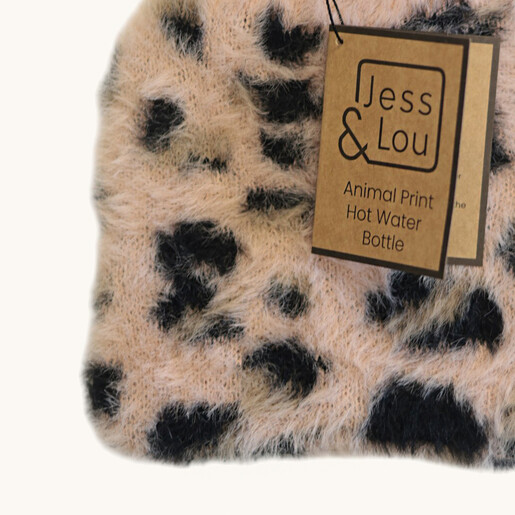 Close-up of pink and black fluffy knitted leopard pattern cover and brand tag