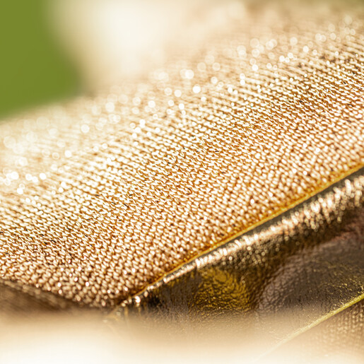 Close-up of shimmering textured gold fabric on Jellycat lightning bolt plush