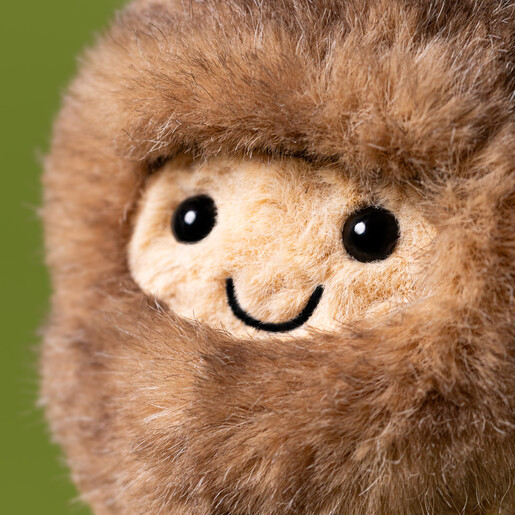 Close-up of the smiling embroidered face and fuzzy yeti hood on the soft toy