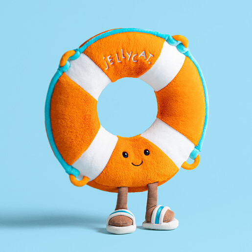 A Pool Lifeguard Ring Plushie Standing Against a Blue Backdrop