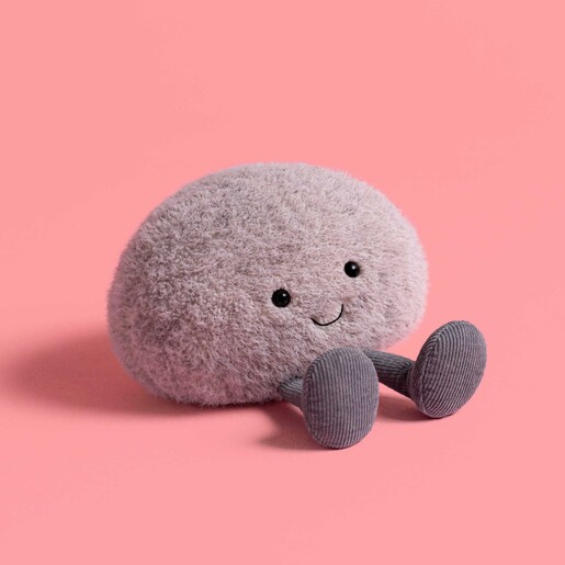 A Fluffy Grey Pebble Cuddly Toy on a Pink Background