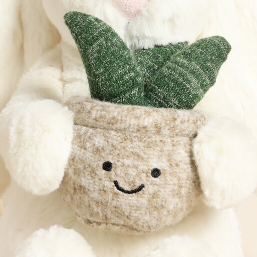 Close Up of Sweet Smiling Plant Plushie Held by Bunny Cuddly Toy