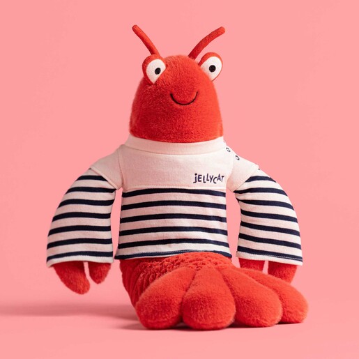 Crustacean Cuddly Toy in Sailor Outfit on Pink Background