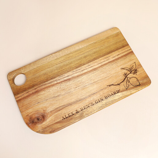 Personalised wooden gin board engraved with a lemon branch on a pale backdrop