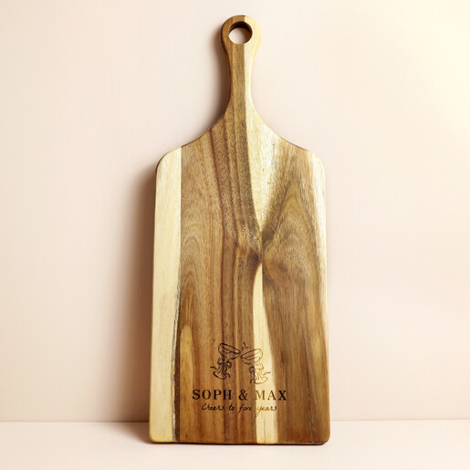 Acacia wood paddle board with handle and engraved fifth anniversary champagne motif