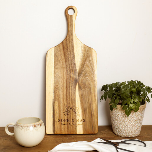 Personalised wooden paddle serving board engraved with champagne glasses for a fifth anniversary