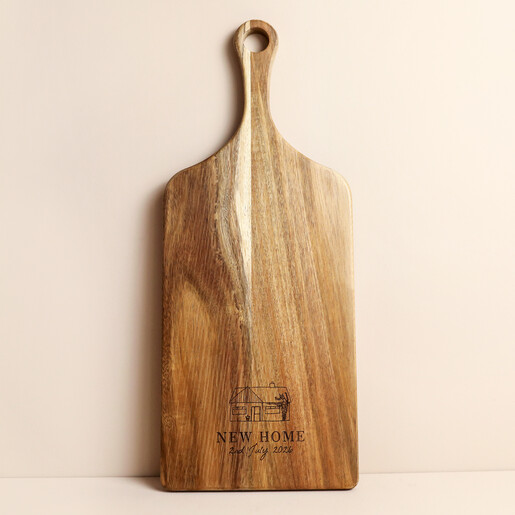 Wooden paddle board personalised with a bungalow illustration and New Home text