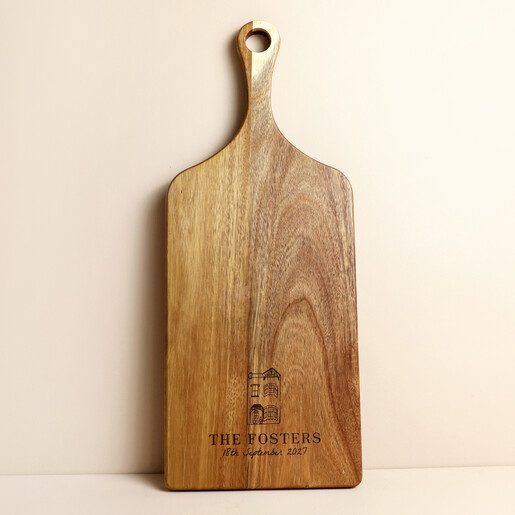 Acacia wood serving board engraved with a townhouse design and custom family name