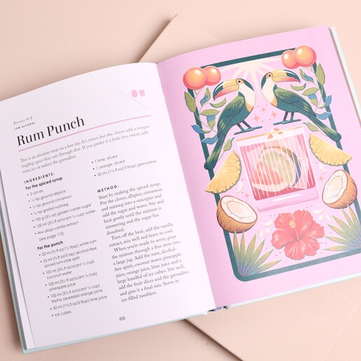 Open book page featuring rum punch cocktail recipe with toucan illustration