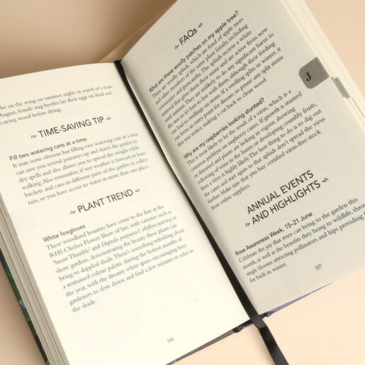 Open pages of the Gardener's Almanac 2027 featuring seasonal tips and ribbon bookmark