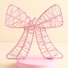 Close up of pink wire ribbon bow light showing intertwined wire details