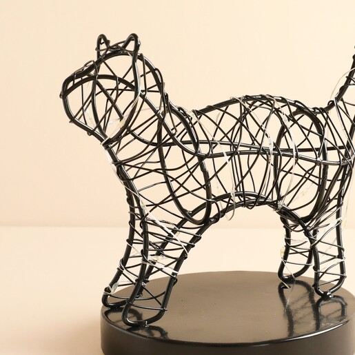 Close-up of black wire cat light showing wrapped fairy lights