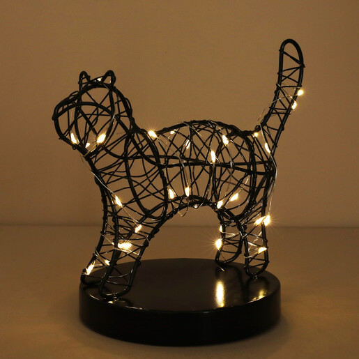 Lit black wire cat table light illuminated with warm glowing fairy lights