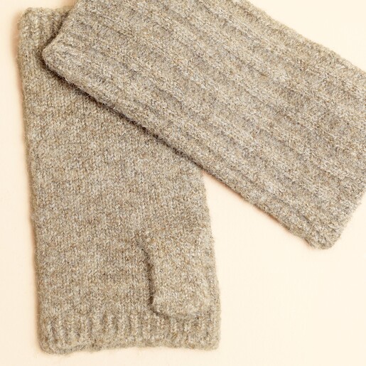 Close-up of neutral ribbed knitted fingerless gloves showing knit texture