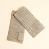 Pair of neutral ribbed knitted fingerless gloves laid flat