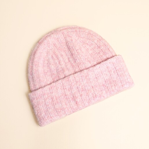 Light pink ribbed knit beanie hat with folded cuff laid flat