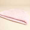 Close up of folded light pink ribbed knit beanie hat